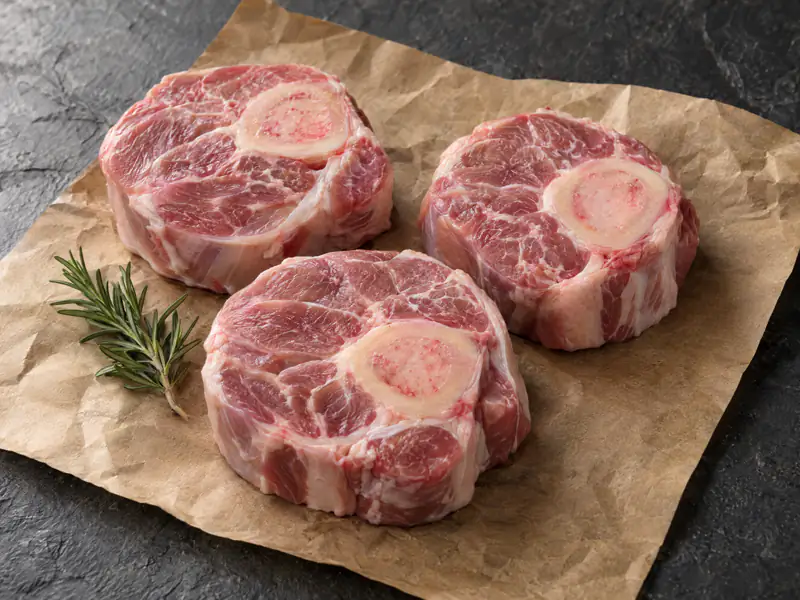 Trois tranches d'osso bucco de porc crues
